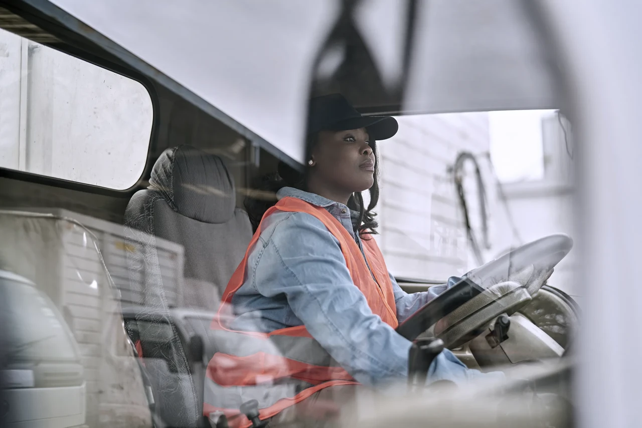 Black Female Truck Driver Photographed Through Window.